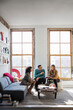 © Cavan Images - Businesswoman showing book on coworkers during discussing in office