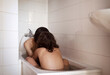 © Cavan Images - Romantic couple sitting in bathtub at home