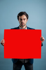 Wall Mural - Surprised man holding red advertising banner