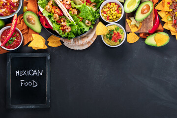 Hispanic mexican food, nachos, guacamole, meat tacos on dark background