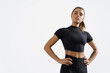 Confident healthy and athletic woman staring determined at camera, holding hands on hips. Sportswoman exercising in sport clothing, training and workout on white background