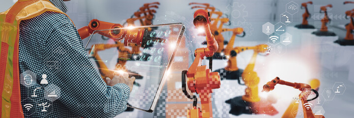 Wall Mural - industry engineer in factory,using smart tablet glass device,control automated robot arm machine lea
