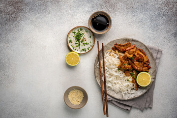 Wall Mural - Asian food rice noodle served with chicken in Teriyaki sauce and sesame seeds, top view