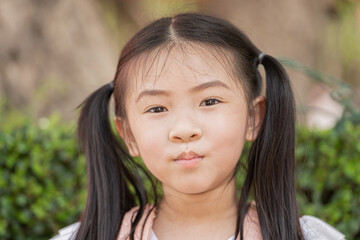 portrait close up face of happy asian girl eating potato chip. she is enjoy and happy with her snack.