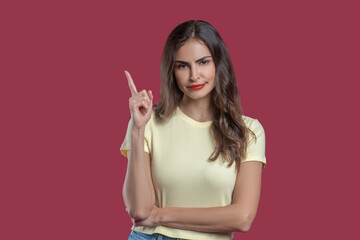 Convincing young woman with raised finger