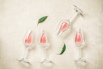 Wall Mural - Glasses with rose wine flat lay on a concrete background. View from above.