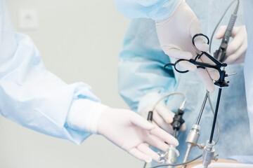 Surgeon performs laparoscopic surgery on the abdomen. Close-up of a laparoscope and doctor's hands