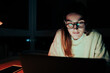 © Prins Productions - Caucasian female student working late a night in home office finishing assignments meeting deadlines