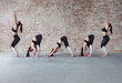© Cavan Images - Sequence of yoga poses by the red brick wall