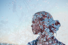 Double Exposure Of A Girls's Profile Silhouette With Pink Flowers