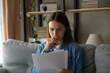 © fizkes - Stressed female student read paper letter with bad news of being expelled from college university failing exam losing scholarship. Young woman client study official bank refusal to grant loan credit