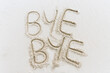 © Cavan Images - Bye Bye written in sand on white beach