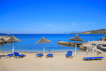 Wall Mural - Beach with sun loungers and sun umbrellas in Ksamil resort