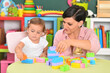 © aletia2011 - young mother and little daughter playing blocks game