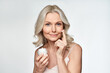 © insta_photos - Smiling 50s middle aged mature woman putting tightening facial cream on face looking at camera. Anti age healthy dry skin care beauty therapy concept, skincare rejuvenation treatment against wrinkles.