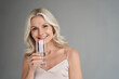 © insta_photos - Smiling healthy thirsty fit mid aged 50s woman holding glass drinking water. Happy mature lady hydrating body with clean filtered fresh mineral water for skin care, beauty, diet nutrition hydration.