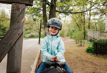 Girl Aged 4 Smiling Whilst Riding A Horse In The Forest