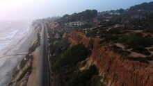 Drone Ariel Shot Of Railroad Along The San Diego Coast At Sunset