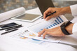 © Suriyo - Hand working business profit report at workplace business office