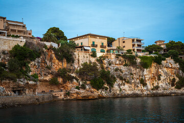 Wall Mural - Houses on a cliff in the Porto Cristo bay on Mallorca island in Spain at evening