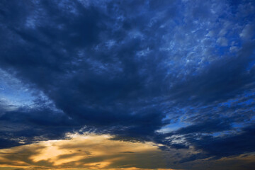 Wall Mural - dark blue orange abstract background. yellow golden sunset. beautiful cloudy sky at sunset. navy blu