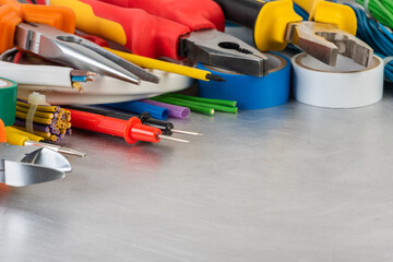 Wall Mural - Tools and accessories used to electrical Installation on grey metal workshop table