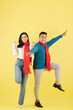© DragonImages - Funny happy young Vietnamese couple dancing in warm winter clothes: sweaters and scarfs