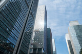 Fototapeta Miasta - Looking Up Blue Modern Office Building