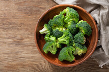 Bowl Of Fresh Broccoli Florets On Wooden Background