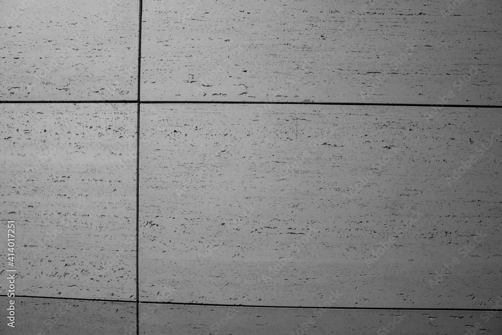 betonowa nowoczesna ściana pokryta szarymi betonowymi płytkami w stylu modern lub loft - obrazy, fototapety, plakaty 