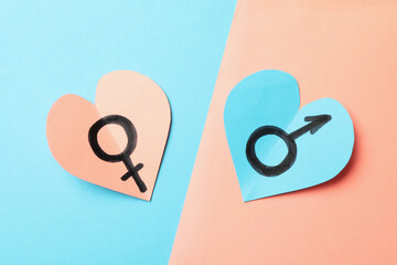 Hearts with male and female symbols on two tone background