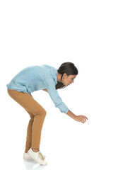 attractive casual woman bending down and trying to grab something