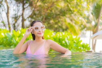 Portrait beautiful young asian woman relax smile enjoy leisure around swimming pool