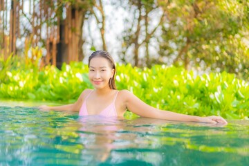 Portrait beautiful young asian woman relax smile enjoy leisure around swimming pool