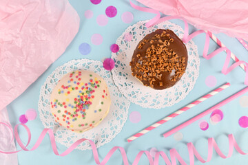 Wall Mural - Top view of 'Berliner Pfannkuchen', a traditional German dessert similar to doughnut with no hole, made from sweet yeast dough fried in fat glazed with chocolate and sprinkles