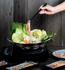 Wall Mural - fresh raw pork, meat ,beef, belly, sliced on square plate  on wood, wooden background,set shabu, hot pot ingredients.