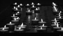 Burning Candles Light In Dark Church. Religious Background. Pray, Memorial, Mourning, Hope Concepts. Black White Historic Photo.	
