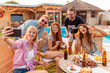 © Impact Photography - Friends taking a selfie at backyard barbecue party