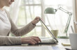 © StockPhotoPro - Woman sitting at desk and working with her laptop