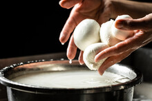 A Woman Working In A Small Family Creamery Is Processing The Final Steps Of Making A Cheese. Italian Hard Cheese Silano Or Caciocavallo, Mozzarella
