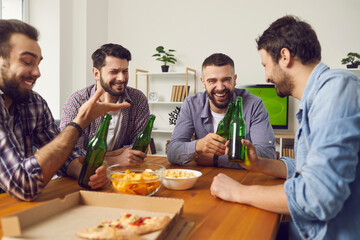 Wall Mural - Home gathering with beer and food for male company. Four cheerful men friends talking during home party sitting at table with beer pizza and snacks together having fun