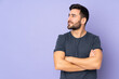 Caucasian handsome man looking to the side over isolated purple background