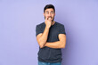 © luismolinero - Caucasian handsome man nervous and scared over isolated purple background