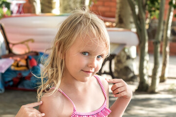 summer landscape little cheerful girl 5 years old blonde posing in front of the camera