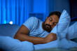 © Syda Productions - people, bedtime and rest concept - indian man sleeping in bed at home at night
