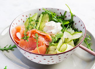 Ketogenic, keto diet. Salted salmon, avocado and cucumber salad with cream cheese in white bowl. Healthy food.