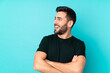 © luismolinero - Caucasian handsome man isolated on blue background happy and smiling