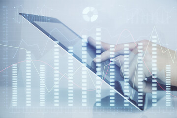 Multi exposure of man's hands holding and using a digital phone and forex graph drawing. Financial market concept.