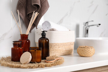 Canvas Print - Soap dispenser, air reed freshener and burning candle on countertop in bathroom