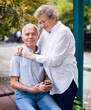 © caftor - mature man with a woman sitting on bench in spring